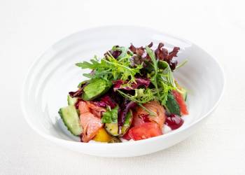 Salad with smoked trout, sour cream sauce and black currant oil