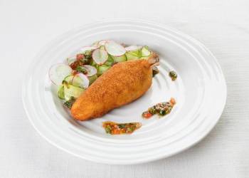 Kiev-style cutlet with cucumber slices and Ceviche sauce