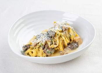 Egg tagliatelle with morels and porcini mushrooms in a creamy sauce